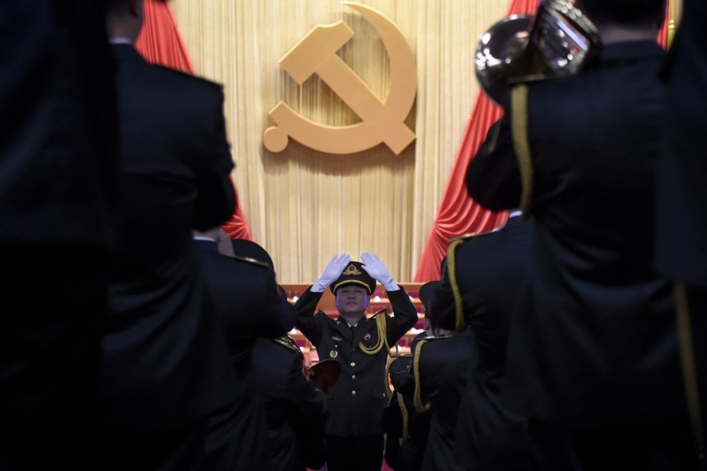 A Chinese People's Liberation Army officer conducts a military band before the opening of the Communist Party's five-yearly congress in Beijing. Photo: AFP