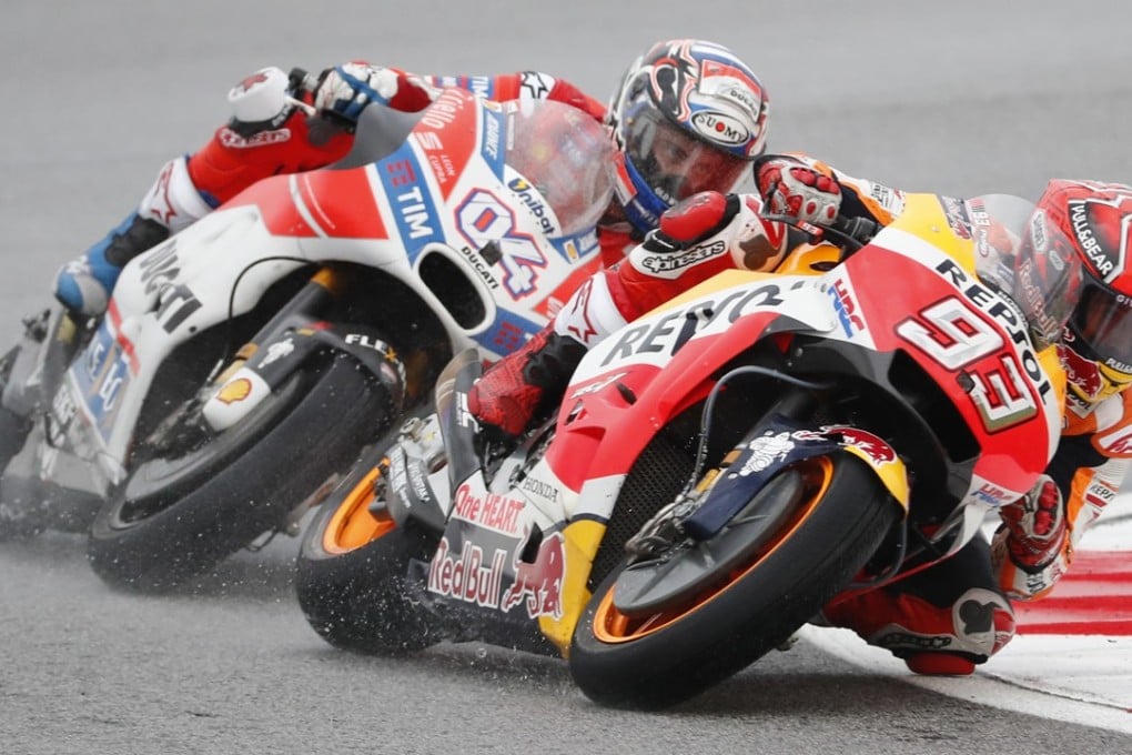 Spain's MotoGP rider Marc Marquez steers his Honda as Italy's MotoGP rider Andrea Dovizioso follows close behind during the Malaysia MotoGP. Photo: AP