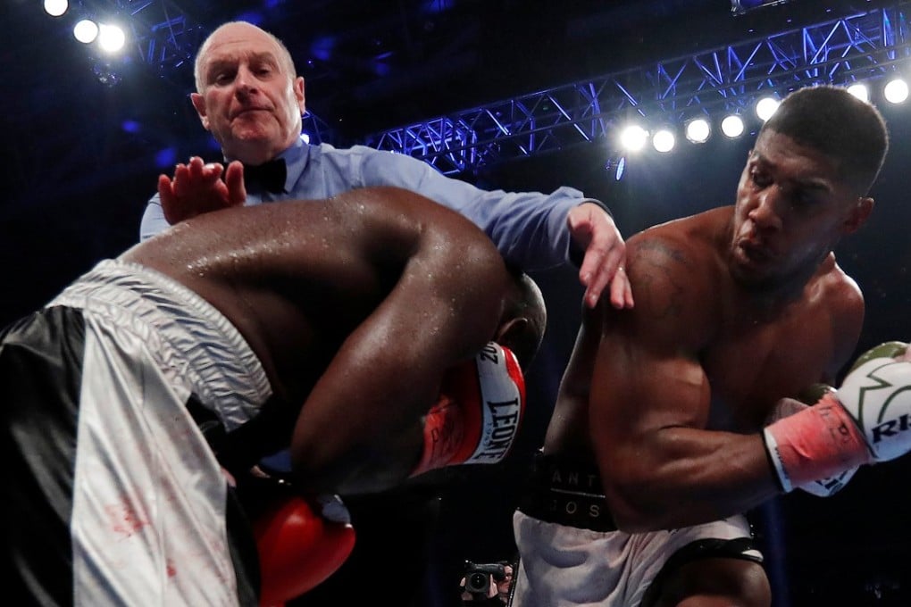 Anthony Joshhua in action against Carlos Takam as the referee steps in to stop the fight. Photo: Reuters