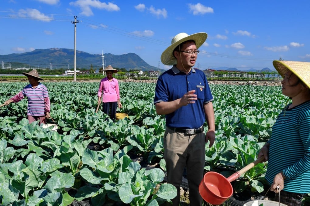 Government efforts over the last decade to bolster loan growth in rural areas has met with mixed results. A communist party official talks to a farmer in Hutou village in southeast China's Fujian Province. Photo: Xinhua