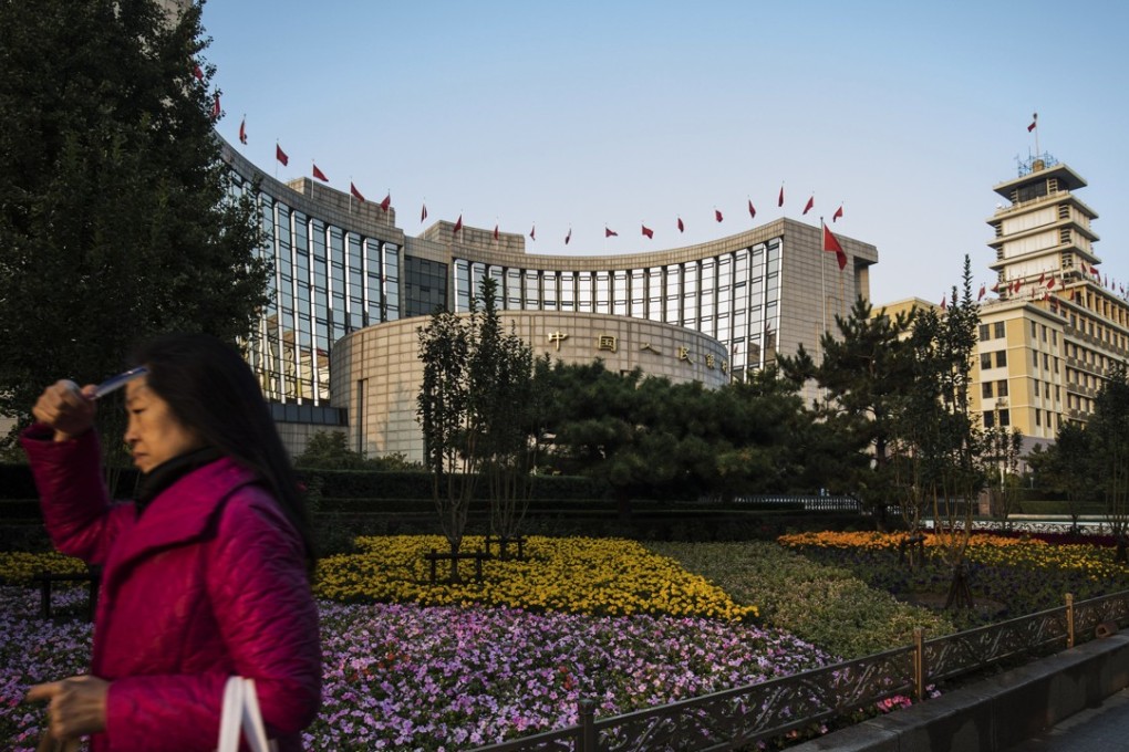 A pedestrian walks past the People's Bank of China headquarters in Beijing, China, on Monday, October 23, 2017. China's central bank is said to have gauged demand for 63-day reverse repurchase agreements for the first time ever. Photo: Bloomberg
