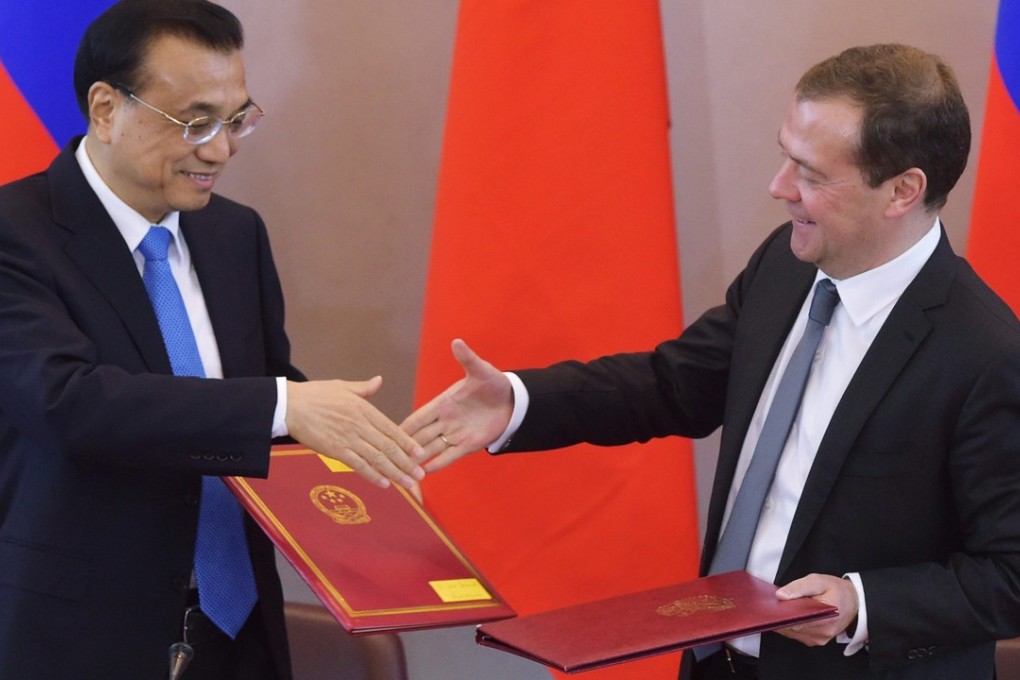 Chinese Premier Li Keqiang shakes hands with Russian Prime Minister Dmitry Medvedev during a signing ceremony following their talks in St. Petersburg last November. Medvedev will be in China this week for talks that are likely to include energy and security issues. Photo: EPA