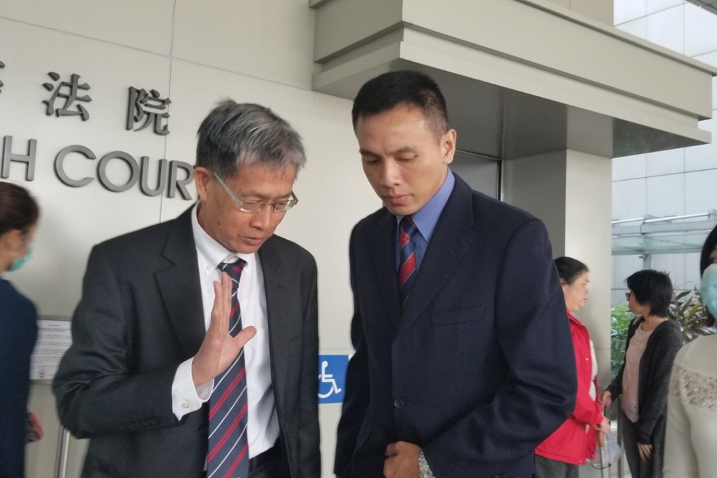 Firefighter Li Chi-sum (right) arrives at the High Court for his judicial review.