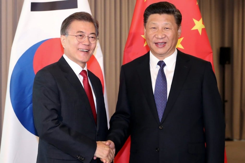South Korean President Moon Jae-in (left) and Chinese President Xi Jinping meet ahead of the G20 summit in July. Photo: EPA