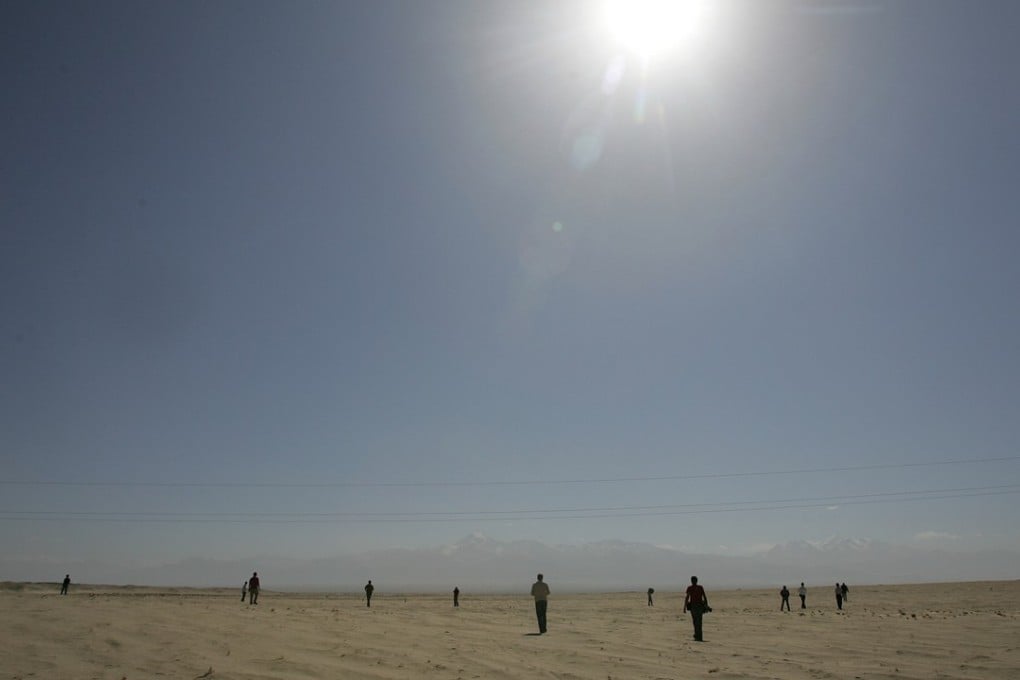 The desert sun shines above the Taklimakan Desert east of Hotan in Xinjiang in October 2006. Photo: AFP