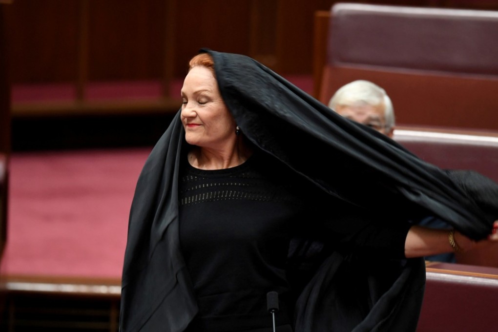 Australian One Nation party leader, Senator Pauline Hanson pulls off a burka in the Senate chamber at Parliament House in Canberra. File photo: Reuters