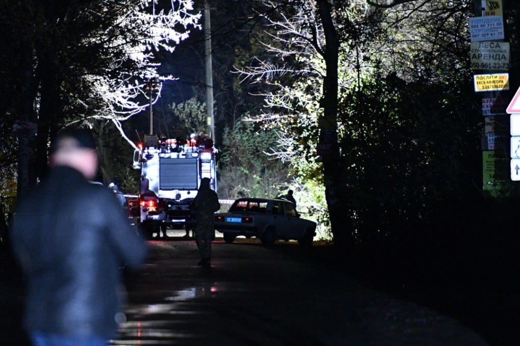 Investigators work at the site where Amina Okuyeva was shot dead in her car in the small town of Hlevakha, some 30km south of Kiev, late on Monday. Chechen volunteer soldier Adam Osmayev, Okuyeva’s husband who was accused of plotting to kill Russian President Vladimir Putin, was wounded ain the attack. Photo: Agence France-Presse