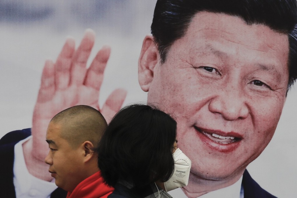 Pedestrians walk past a poster of Chinese President Xi Jinping on a street in Beijing on October 26. China's ruling Communist Party has praised Xi as a Marxist thinker, adding to the propaganda promoting Xi’s personal image as he begins his second five-year term as leader. Photo: AP
