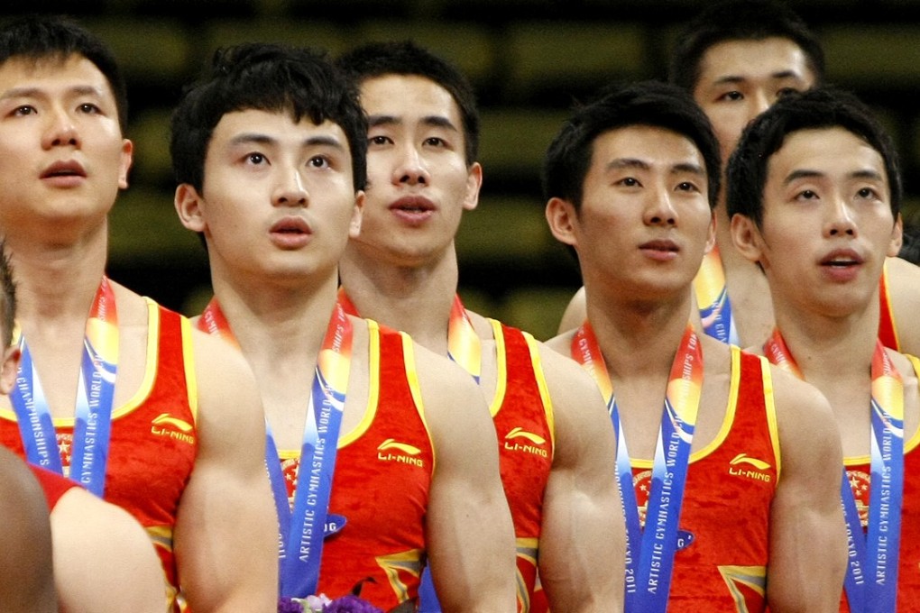 Chinese gymnasts sing along as the national anthem is played during the awards ceremony for the men’s team final at the Artistic Gymnastics World Championships in Tokyo in October 2011. Photo: AP