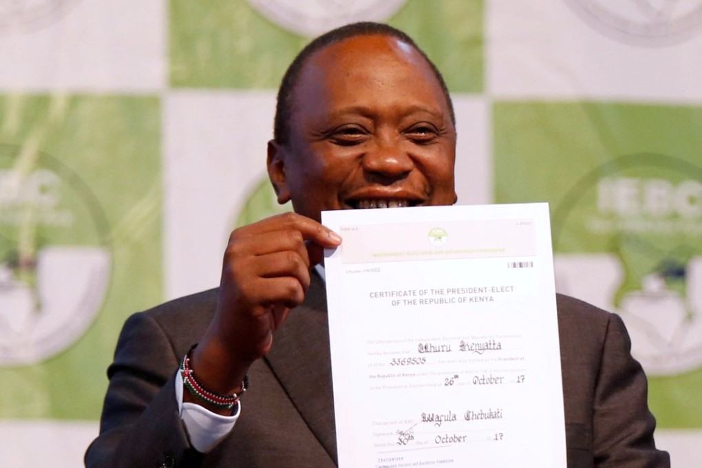Incumbent President Uhuru Kenyatta holds the certificate of President-Elect of the Republic of Kenya after he was announced winner of the repeat presidential election at the National Tallying centre in Nairobi on Monday. Photo: Reuters