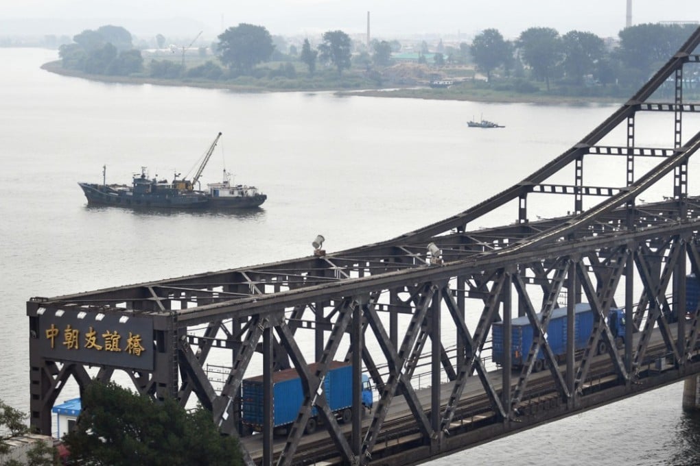 Trucks drive over the Sino-Korean Friendship Bridge from Chinese border city Dandong towards North Korea’s Sinuiju in September. Photo: Kyodo