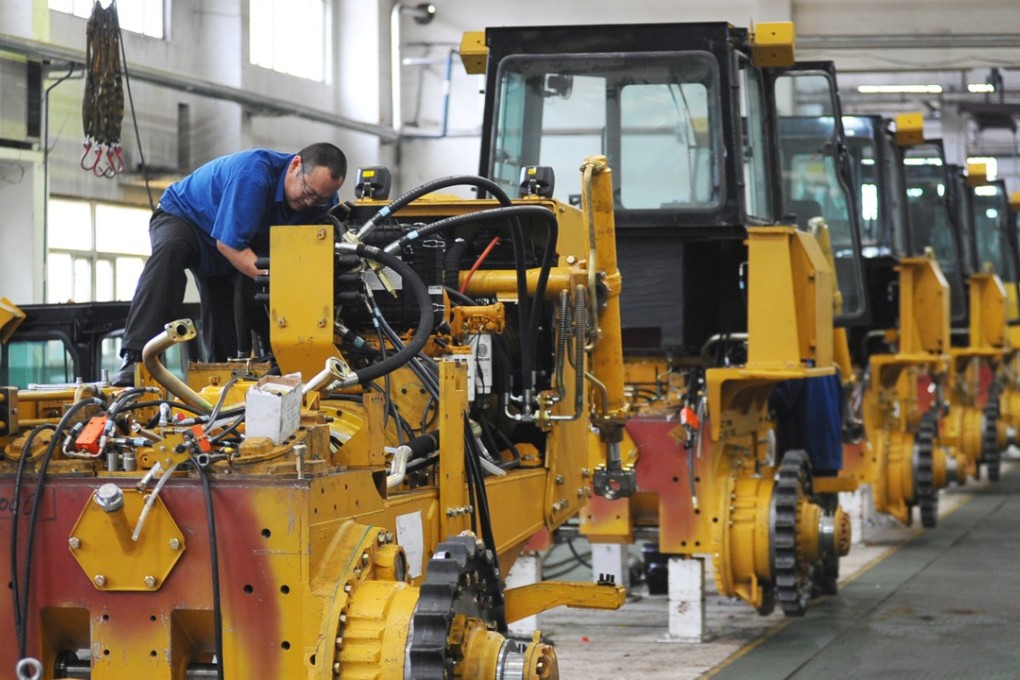 A file picture of a worker at a bulldozer factory in Hebei province. Photo: Reuters