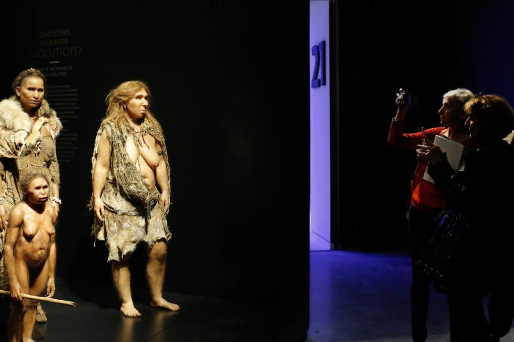 Visitors take pictures of models representing Flores, human and Neanderthal women in the “Musee des Confluences”, a new science and anthropology museum in Lyon, central France. Photo: AP