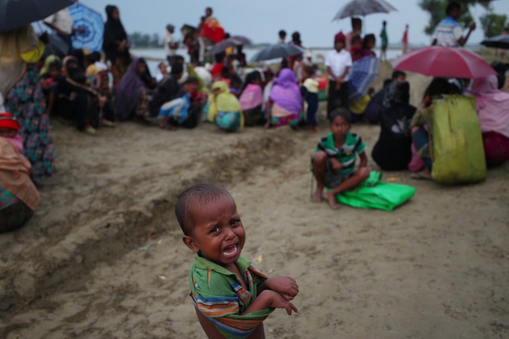 A Rohingya refugee boy cries as he waits to receive permission from the Bangladeshi army to continue after crossing the Bangladesh-Myanmar border, at a port in Teknaf, Bangladesh. Photo: Reuters