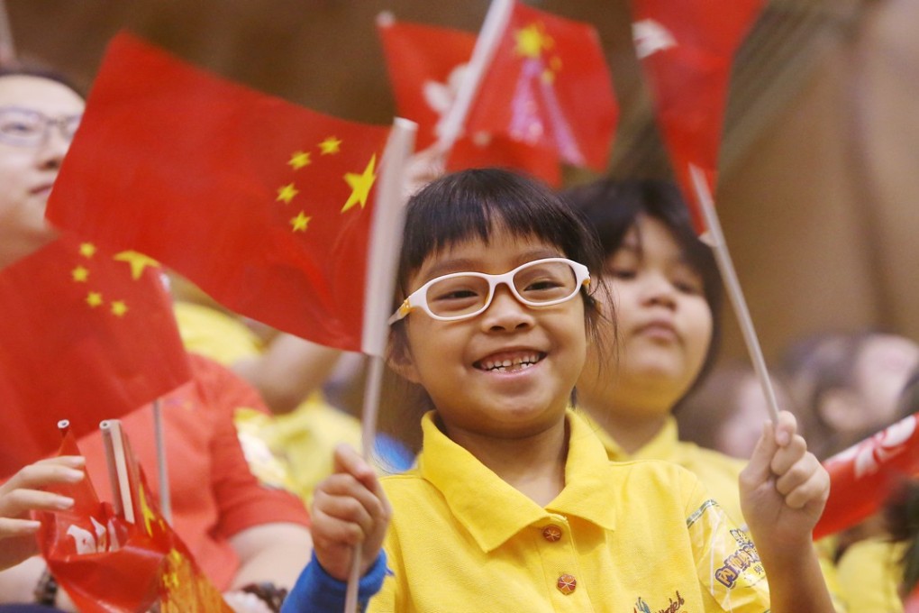 A child waves Chinese and Hong Kong flags as the mainland Olympians delegation attend an exchange session with Hong Kong youths in Sha Tin. Photo: Dickson Lee