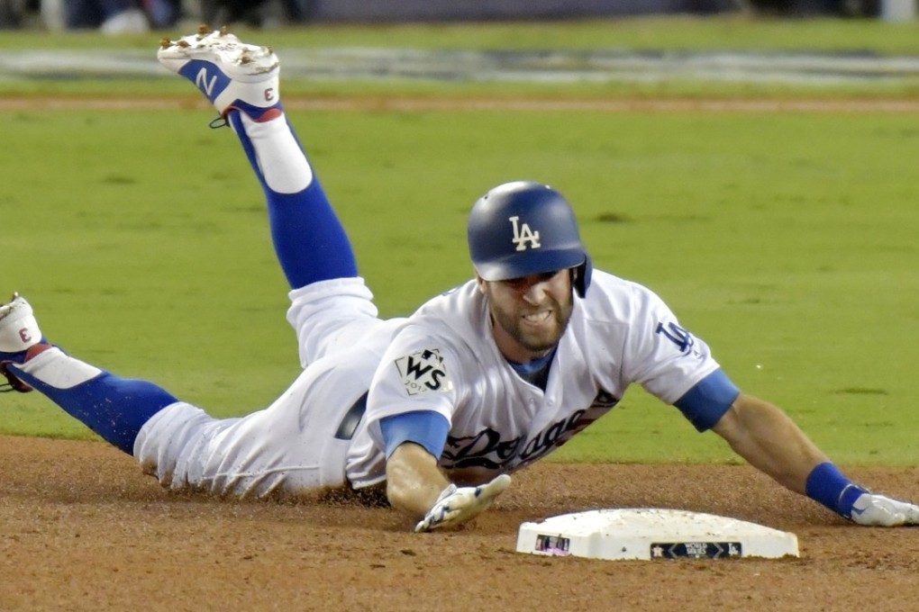 Chris Taylor of the Los Angeles Dodgers slides into second base for a double in the sixth innings of the fame six win against the Houston Astros. Photo: Kyodo