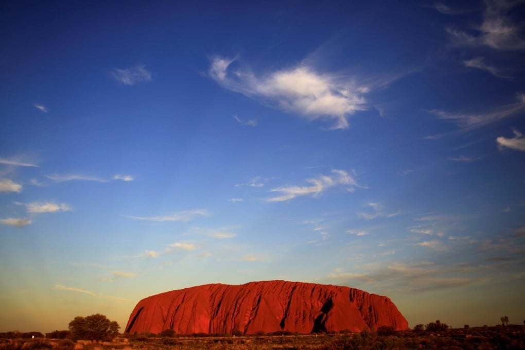 Climbing the world’s largest monolith Uluru was banned Wednesday amid concerns it was becoming a “theme park”, undermining the giant red rock’s deep cultural significance. File photo: Reuters