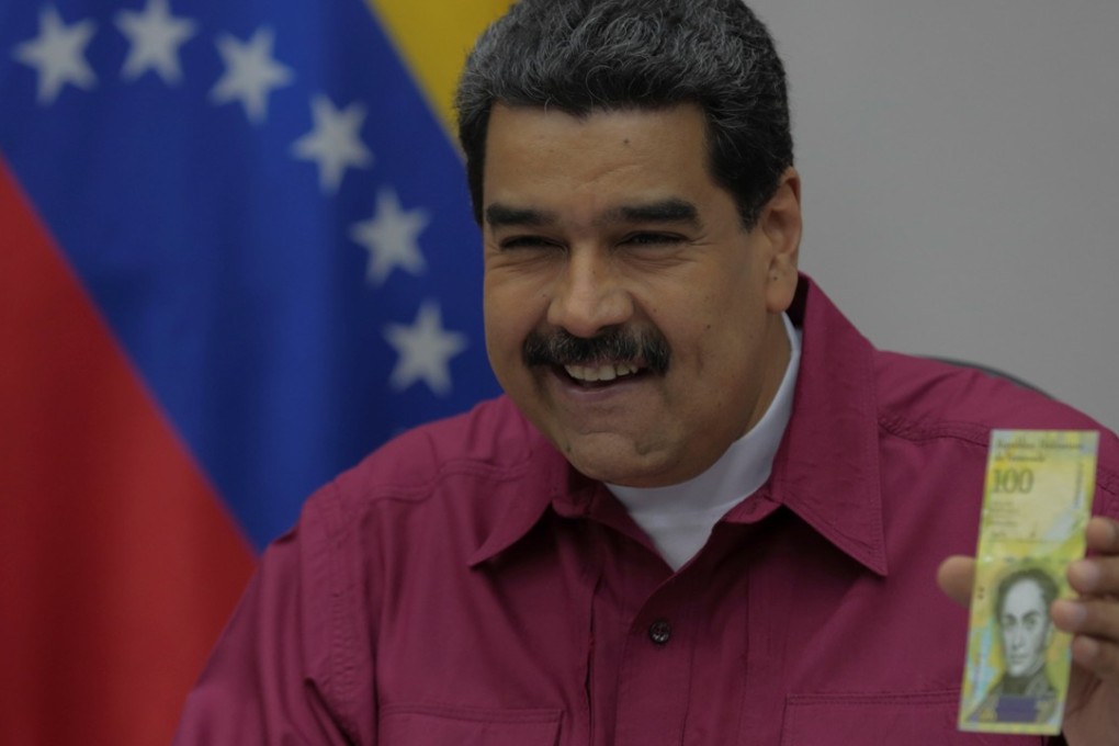 Venezuela’s President Nicolas Maduro with the new 100,000-bolivar note in Caracas. Photo: Reuters
