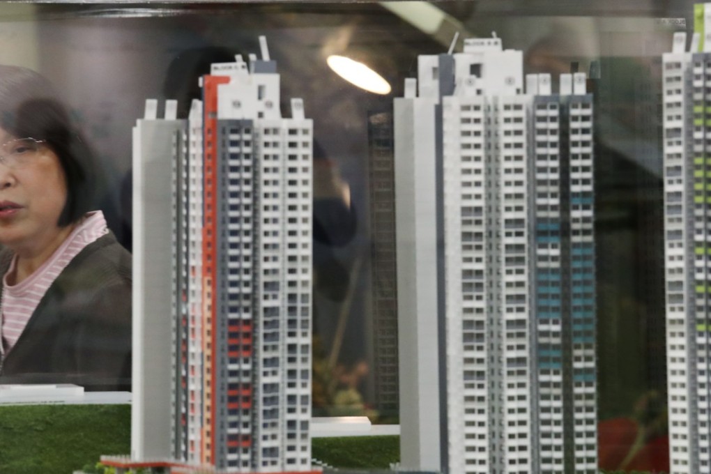 A woman walks past a model of a development after the Housing Authority opened applications for Home Ownership Scheme flats, in Lok Fu, in March. Photo: Nora Tam