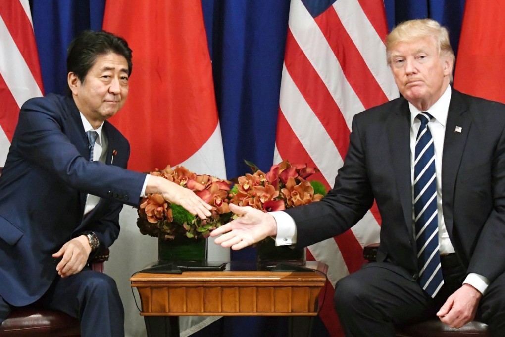 Japanese Prime Minister Shinzo Abe and US President Donald Trump shake hands during their summit meeting in New York on September 21. Photo: Kyodo
