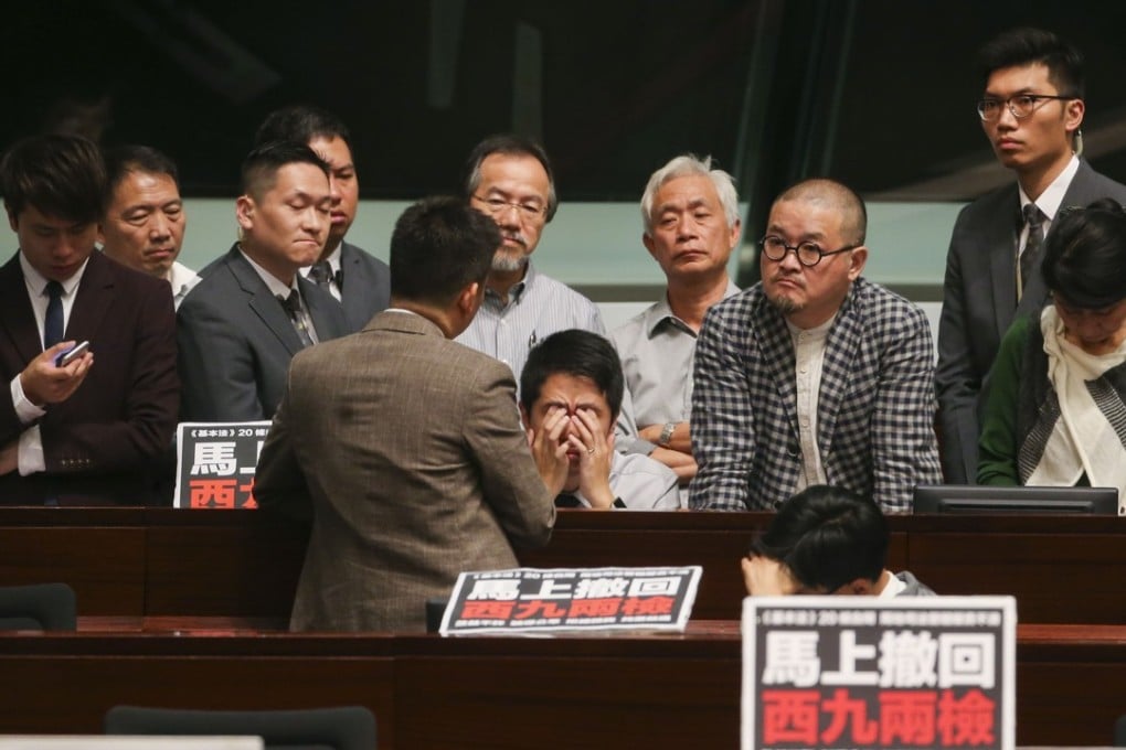 Ted Hui Chi-fung (centre) and other pan-democrat members attend the Legislative Council meeting on the co-location motion. Photo: David Wong