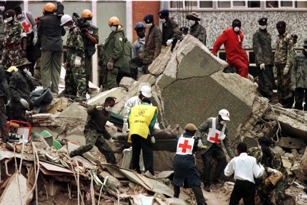 A body is carried from the wreckage of the US Embassy in Nairobi in 1998 after an Al-Qaeda bombing. US prosecutors said al-Qaeda had the backing of Iran and Hezbollah in their 1998 indictment of Osama bin Laden following the attacks in Kenya and at the US embassy in Tanzania that killed 224 people, including 12 Americans. Photo: AFP