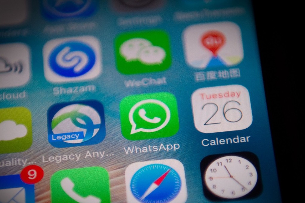 The Whatsapp application icon on a smartphone screen. Photo: AFP