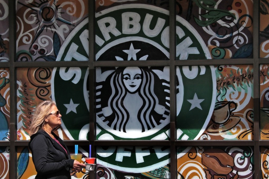 A woman walks past a Starbucks coffee shop in Sewickley, Pennsylvania. Photo: AP