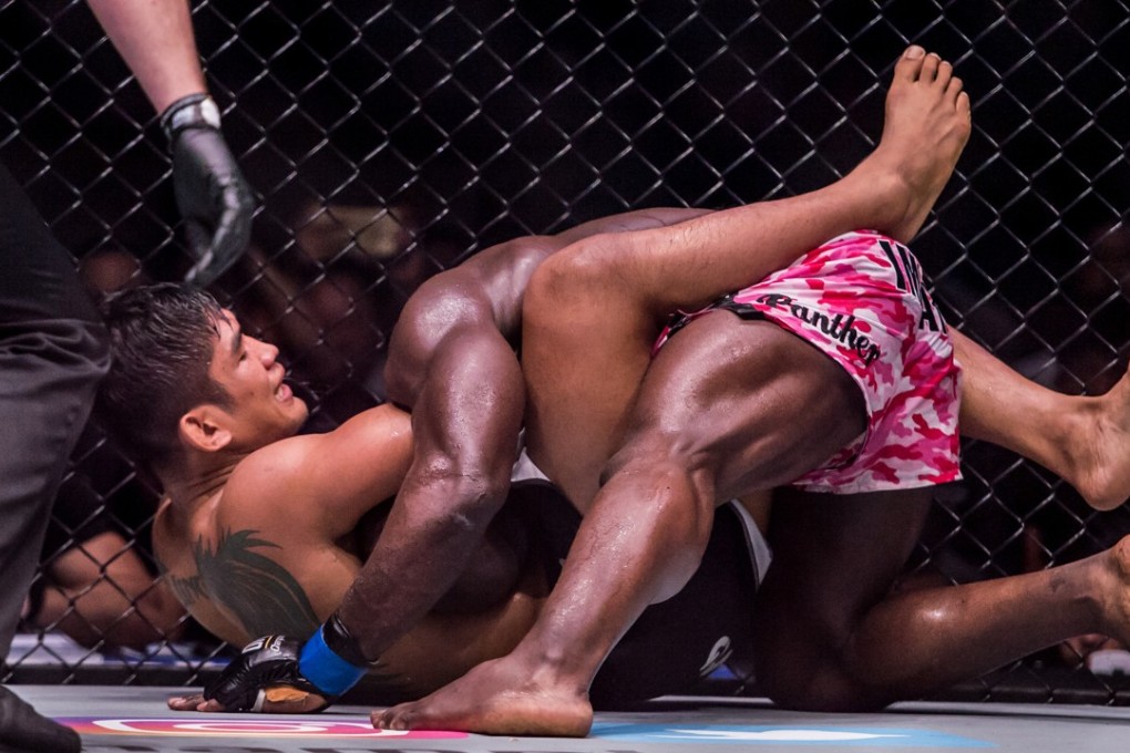 “Burmese Python” Aung La Nsang gets to grips with Alain “The Panther” Ngalani in One Championship in Yangon. Photo: Singapore Maven