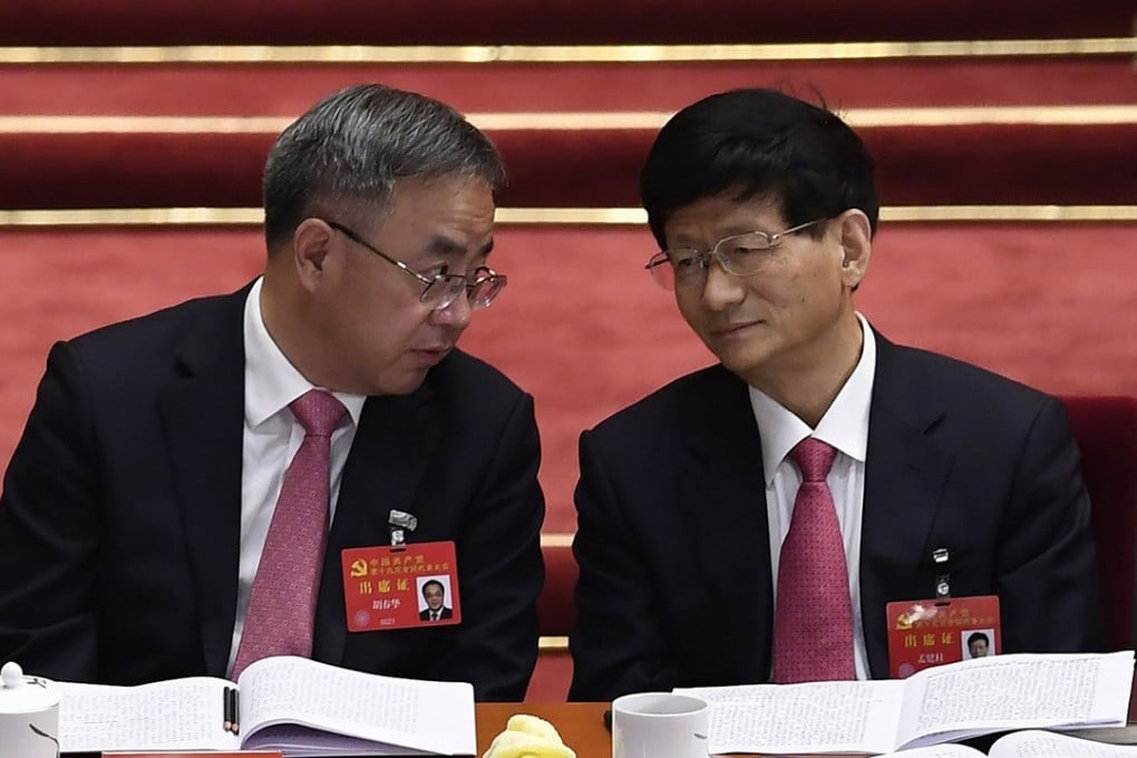 Politburo members Hu Chunhua (left) Meng Jianzhu confer during the Communist Party’s national congress last month. Grey hair is making a comeback among some of the senior ranks of power Photo: AFP