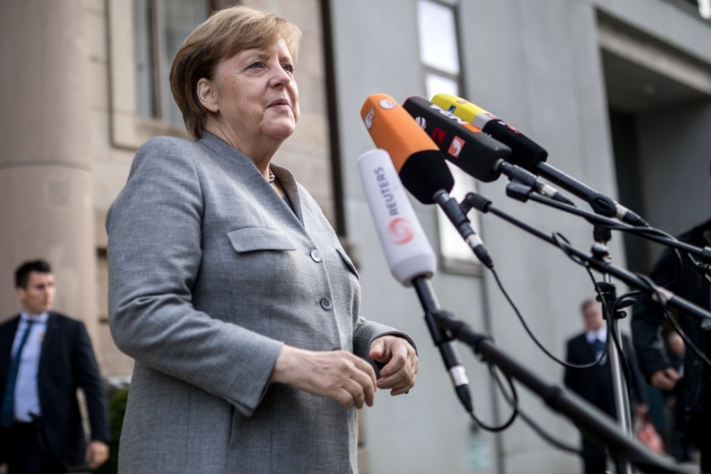 German Chancellor and leader of the Christian Democratic Union (CDU) party, Angela Merkel talks to journalists as she arrives for exploratory talks with members of possible coalition parties to form a new government on November 3, 2017 in Berlin. Photo: DPA via Agence France-Presse