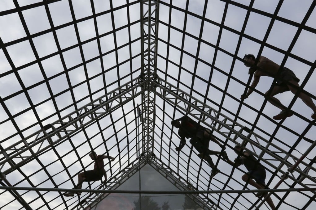 Runners take on an obstacle at the Spartan Race at Kam Tin Country Club. Photos: Jonathan Wong