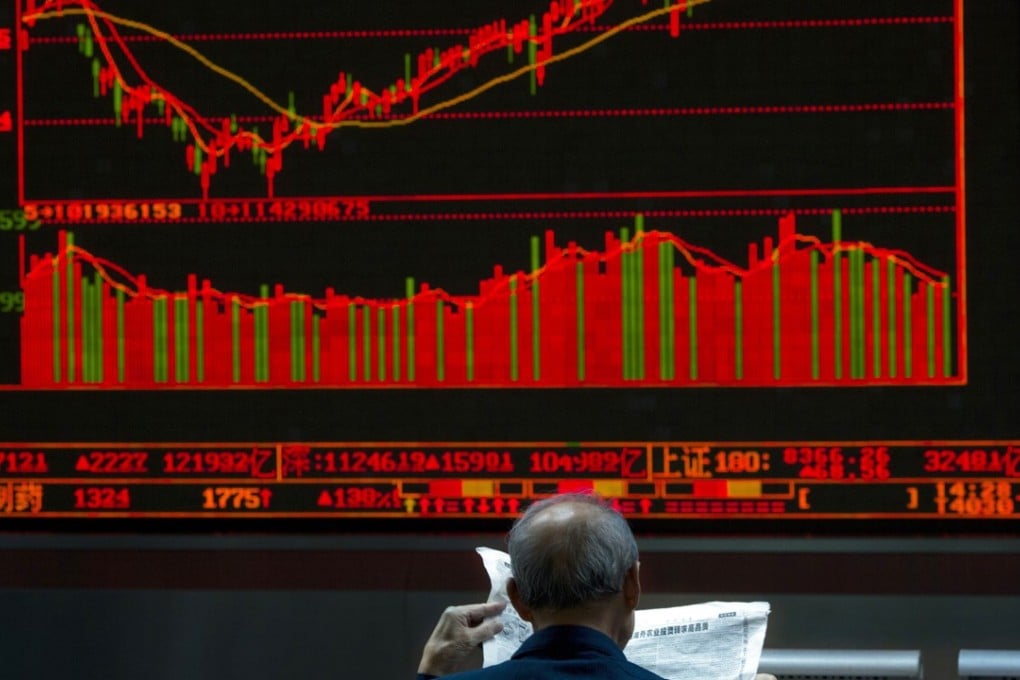 An elderly investor in front of a graph showing Chinese stock prices at a brokerage in Beijing. Photo: AP