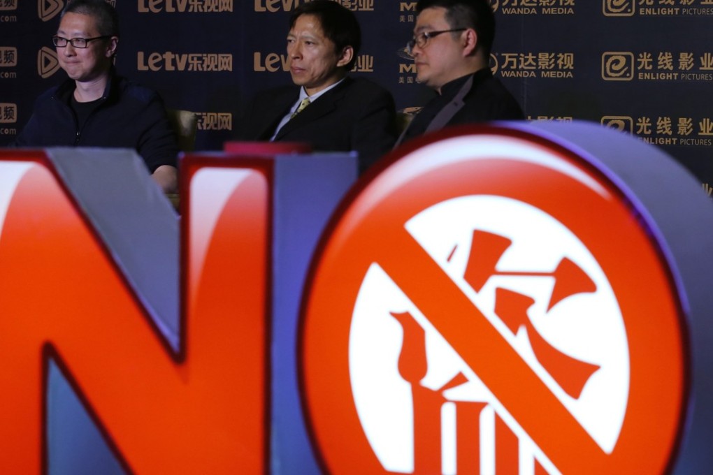 Victor Koo, CEO of Youku Tudou (left), Sohu CEO Charles Zhang (centre) and Tencent senior vice-president Seng Yee Lau stand behind a sign symbolising action against copyright violation during a news conference in Beijing in 2013. Online piracy and copyright violation is an ongoing problem in Asia. Photo: Reuters