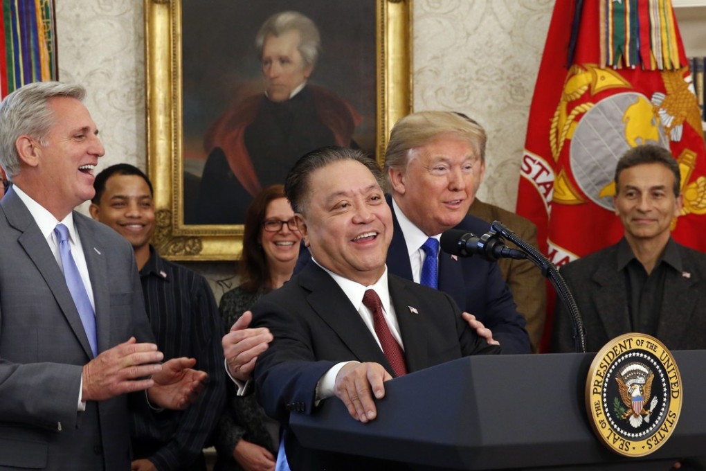 President Donald J. Trump hugs Broadcom CEO Hock Tan as Tan announces the repatriation of his company to the United States. Broadcom has announced a near hostile takeover bid for Qualcomm. Photo: Abaca Press/TNS