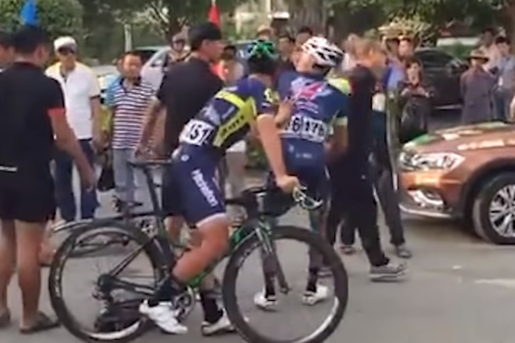 A confrontation breaks out as Wang Xin picks up his bike following the fall. Photos: YouTube