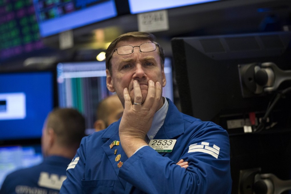 A relaxed-looking New York trader pauses on the floor of the New York Stock Exchange. Photo: AFP