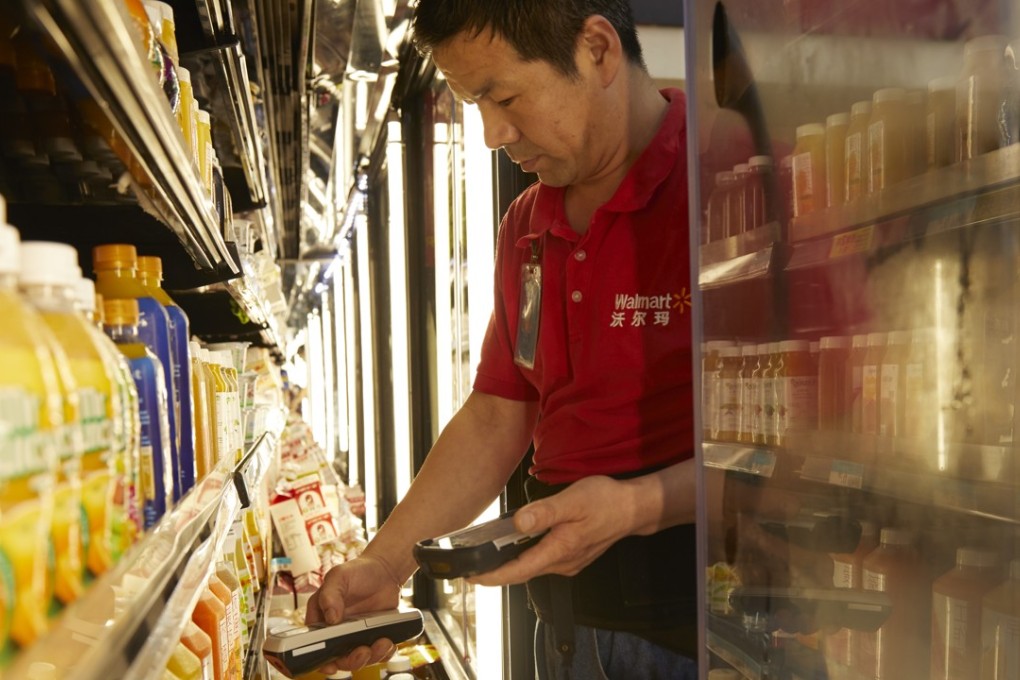 A compliance officer inspecting products at a Walmart store in Shenzhen. Photo: SCMP