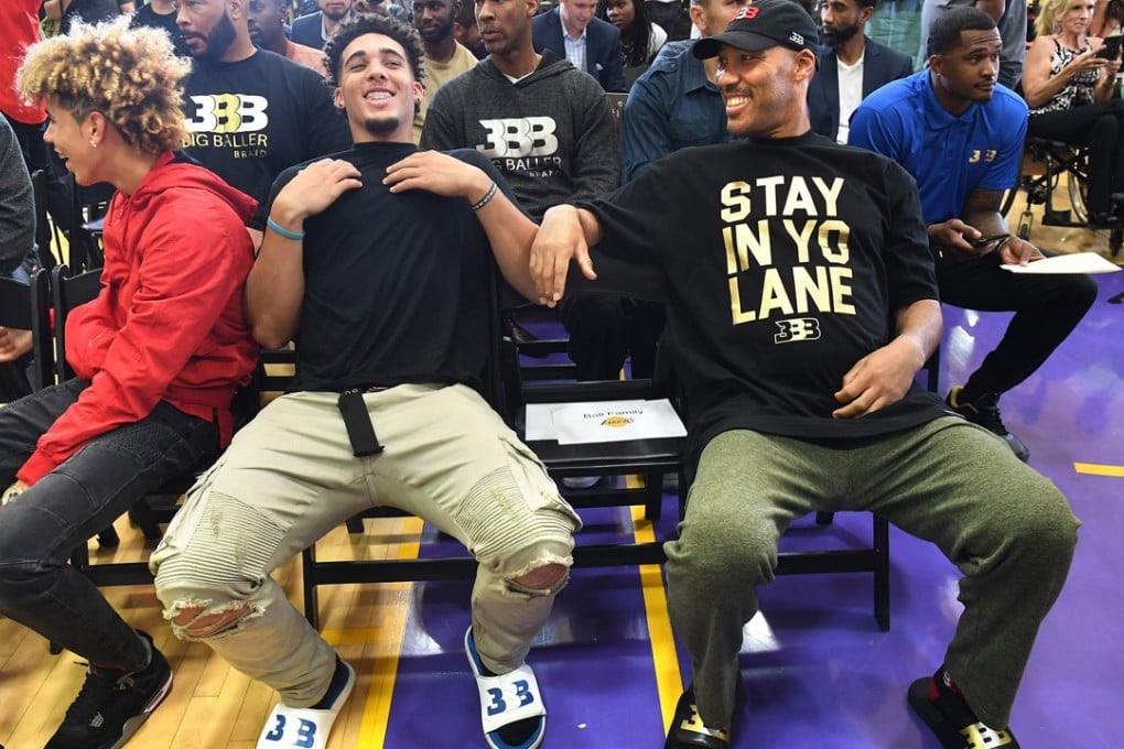 LaVar Ball sits with his sons LaMelo (L) and LiAngelo as the Los Angeles Lakers hold a news conference introducing the Lakers’ first-round draft pick Lonzo Ball. Photo: TNS