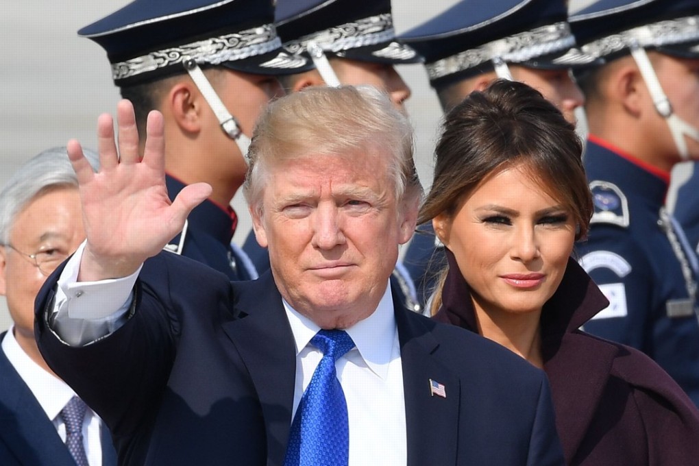US President Donald Trump waves as he arrives at an air base in South Korea on Tuesday. He is expected to arrive in China on Wednesday before holding talks with President Xi Jinping the following day. Photo: AFP