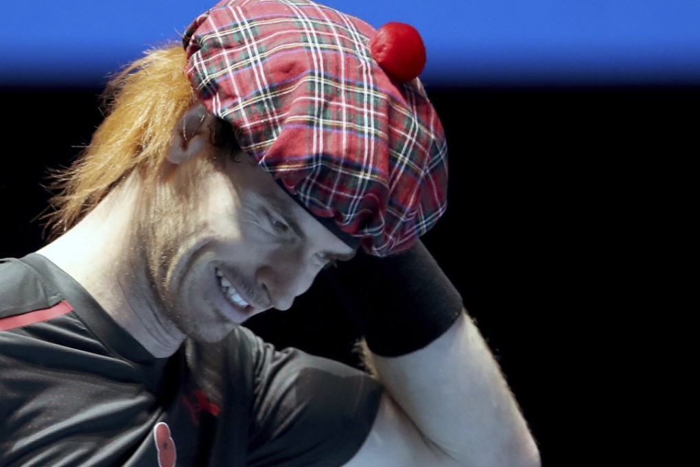 Andy Murray wears a traditional Scottish tartan hat with added ginger hair during a comical exhibition match against Roger Federer in Glasgow. Photo: AP