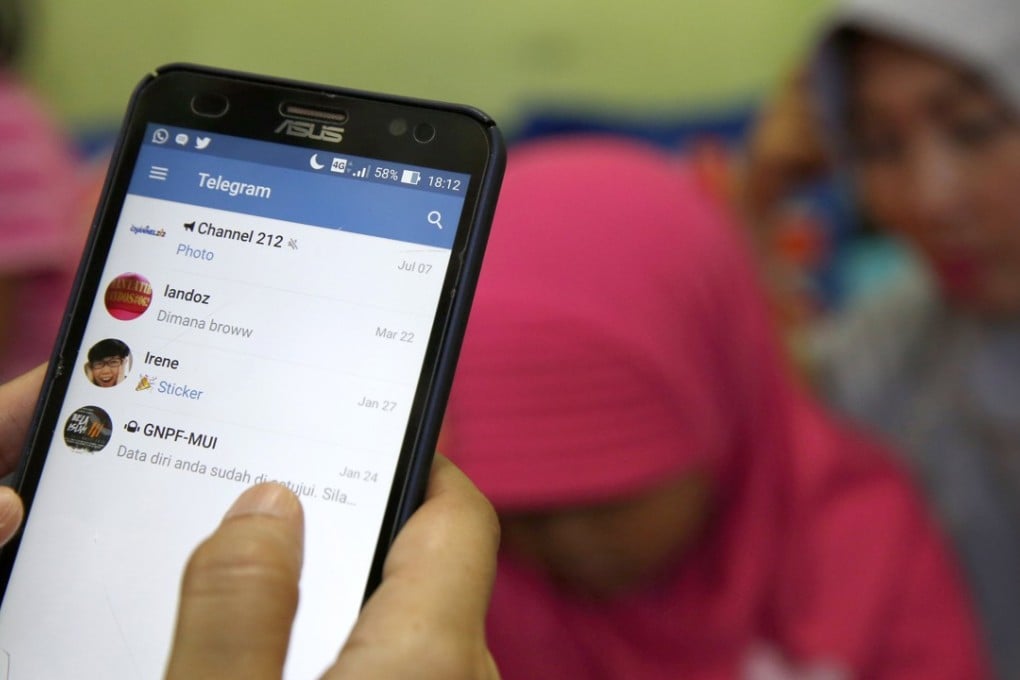 An Indonesian girl opens the Telegram messaging app in Jakarta. The app was temporarily blocked due to concerns it was being used by radical groups. Photo: EPA