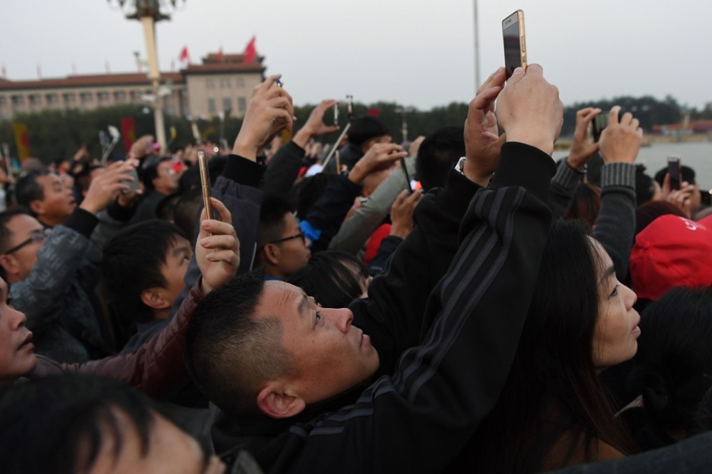 Spectators jostle to photograph the flag-raising ceremony at Tiananmen Square. Photo: AFP