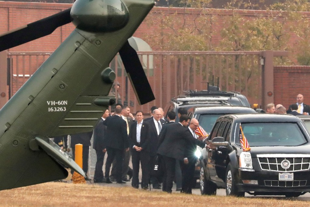 White House senior staff discuss the fog situation as US President Donald Trump sits in his car after being grounded from an attempt to visit the demilitarised zone (DMZ). Photo: Reuters
