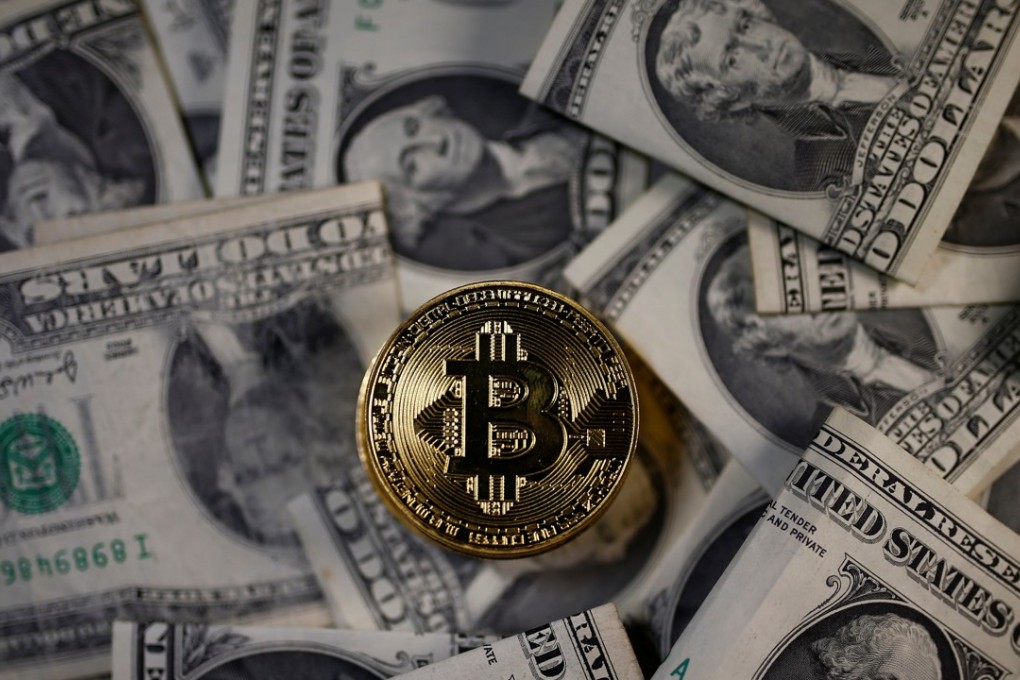 A bitcoin (virtual currency) coin placed on US dollar banknotes is seen in this illustration picture. Photo: Reuters