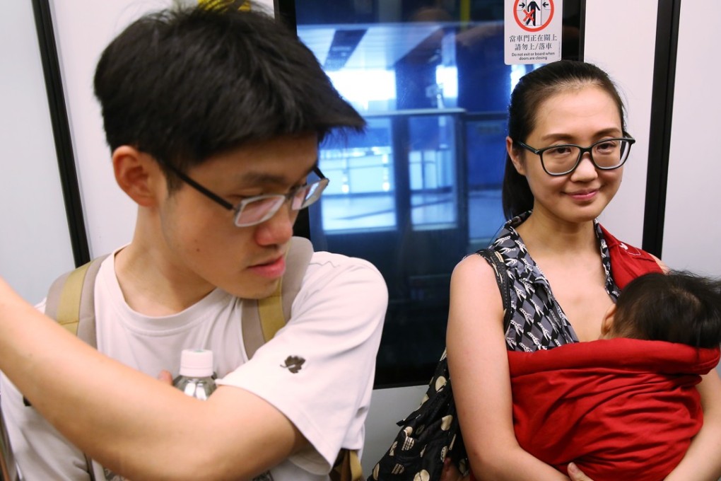 A mother breastfeeds her baby on a train at Tai Wai MTR station during a breastfeeding flash mob calling for legislation to protect nursing mothers. Photo: Sam Tsang