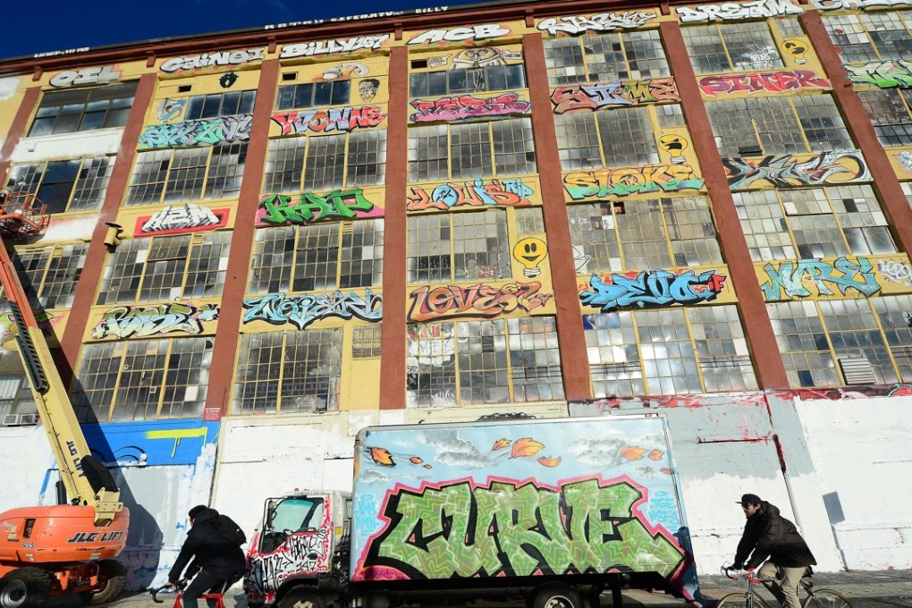 A 2013 file photo shows New York's graffiti iconic spot "5Pointz” as it stands defaced with white paint covering most of the art work. A New York jury has decided that a developer broke US federal law by whitewashing over and demolishing works of graffiti art, recommending that he pay damages. Photo: Agence France-Presse