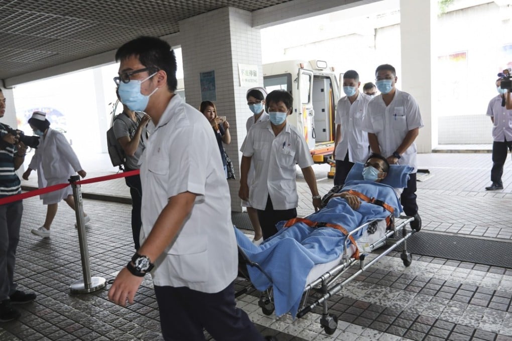 Patients from Queen Elizabeth Hospital are transferred to privately run St Teresa's Hospital in Kowloon City in July as part of a plan to ease overcrowding in the public health sector. Photo: Edward Wong