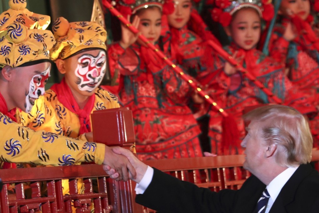President Donald Trump shakes hands with a Chinese opera performer during his visit to the Forbidden Palace in Beijing. Photo: AP