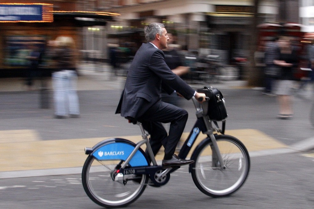 A commuter rides a hired bicycle in London, where bike sharing has become very popular. Photo: AP
